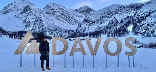 The author in front of the picturesque mountain scenery in Davos